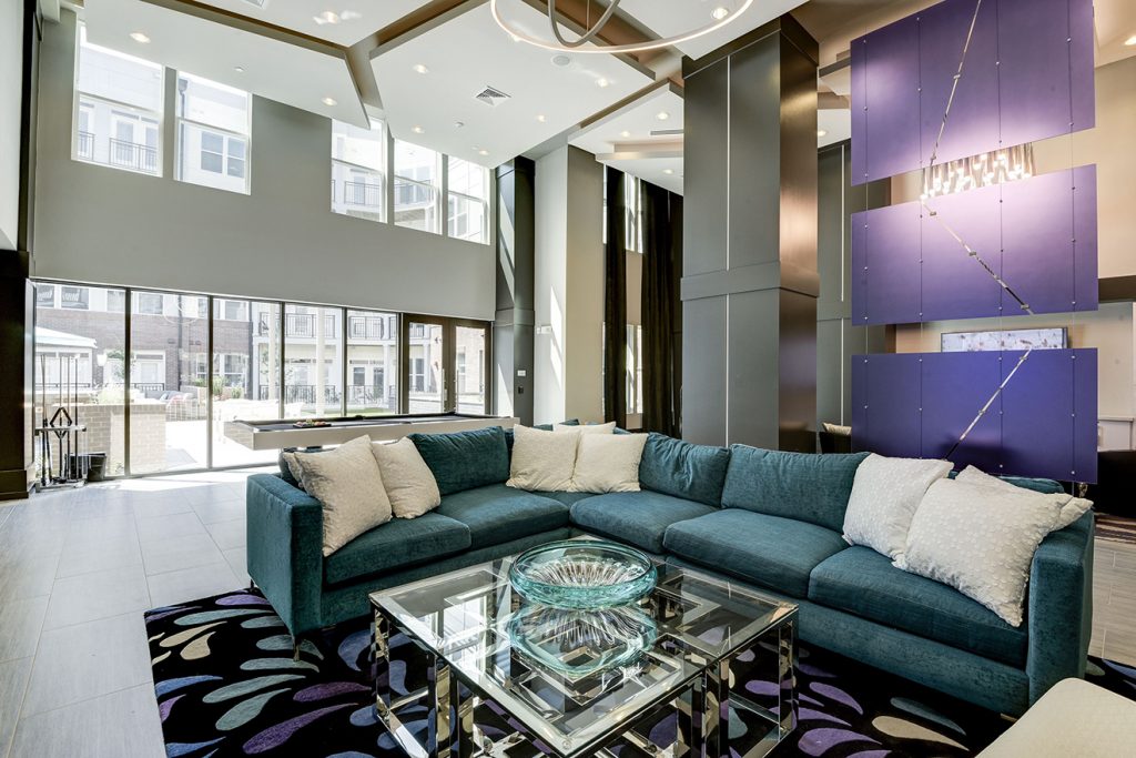 Clubroom with lush sectional sofa, accent lighting, and pool table