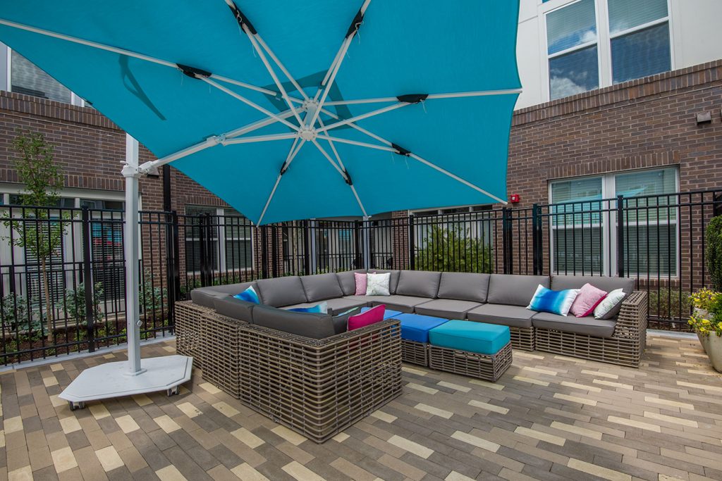 Outdoor lounge seating with sectional sofa and large umbrella