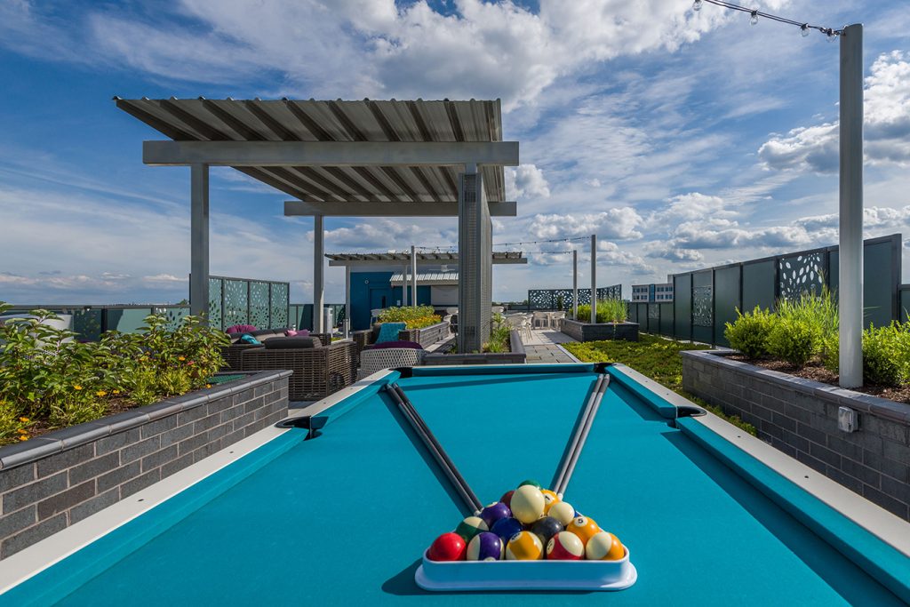 Rooftop terrace with covered lounge seating and pool table
